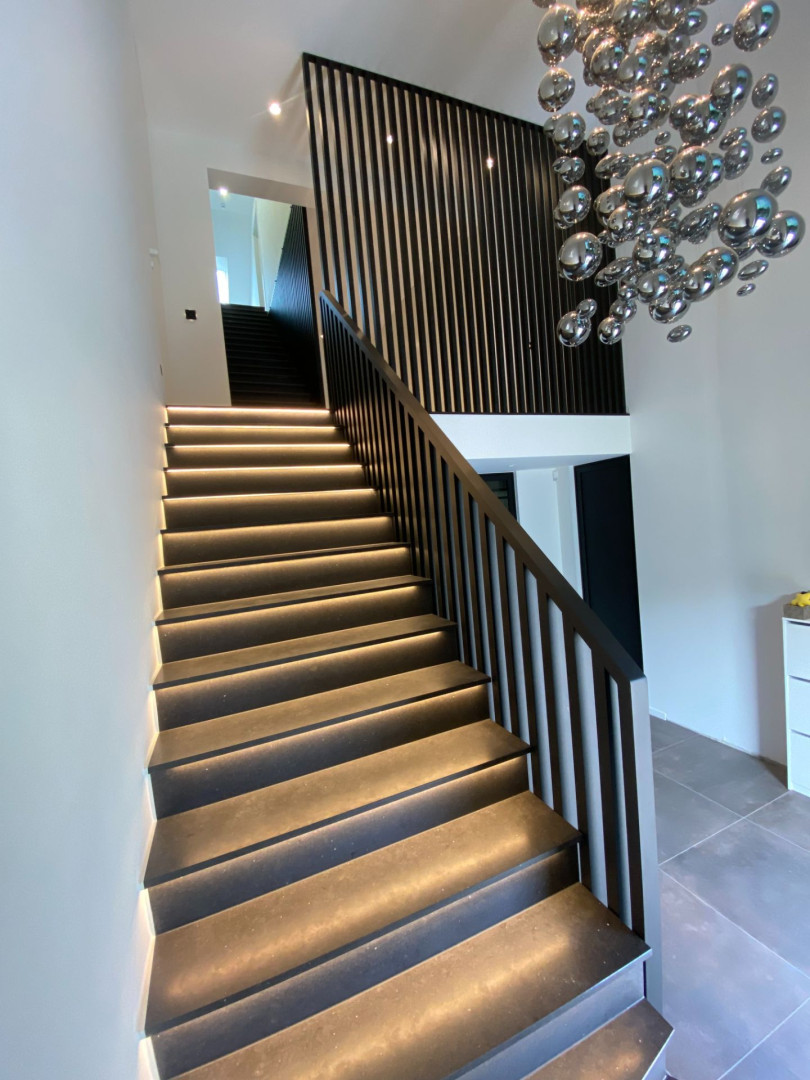 Moderne houten trap met zwarte moderne balustrade